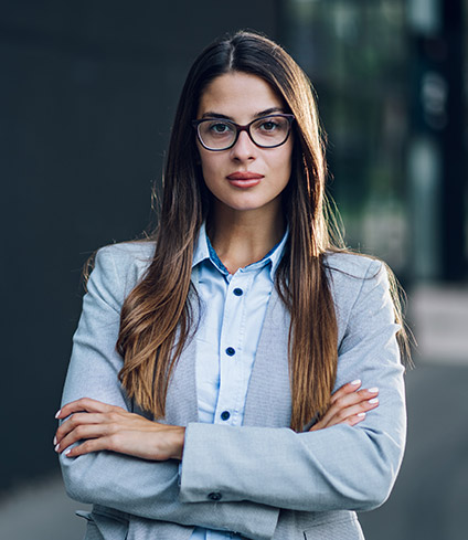 business-woman-standing-outside-the-office-buildin-8DSNDV8.jpg